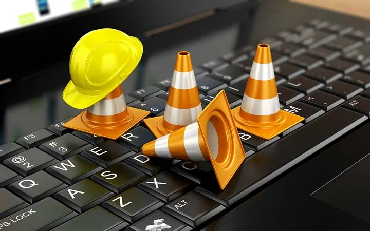 keyboard with cones & a hard hat for website maintenance