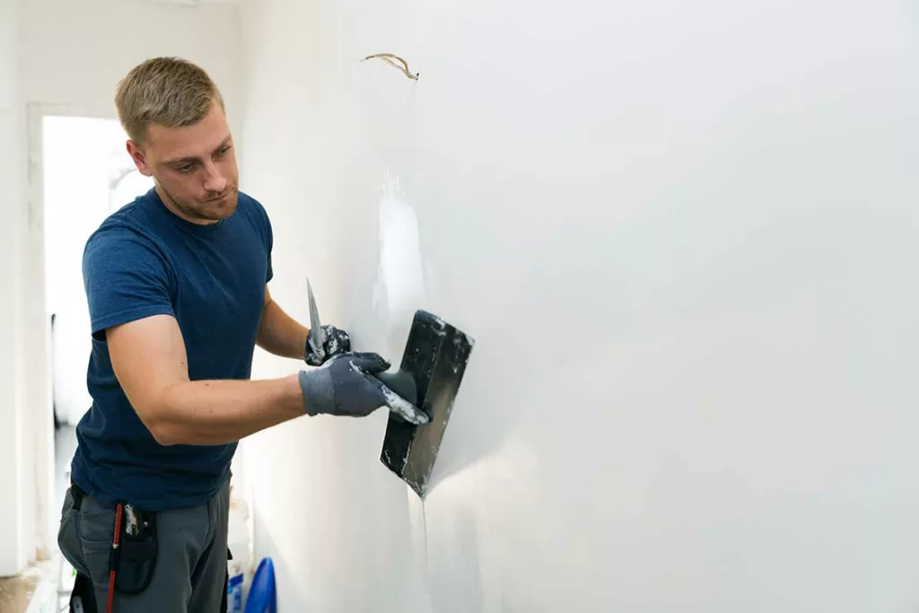 A man plastering a wall